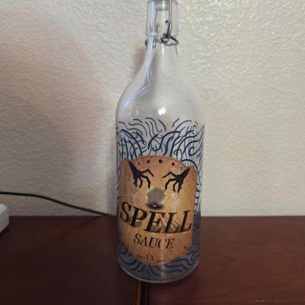 Spell Sauce glass bottle with flip top from Renaissance fair 2023